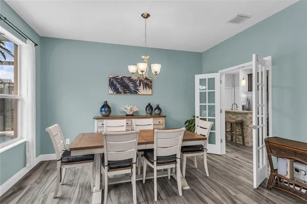 a view of a patio with couches table and chairs and potted plants