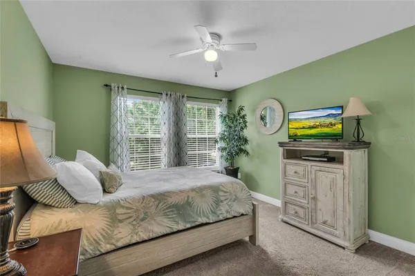 an aerial view of a house with a yard and lake view