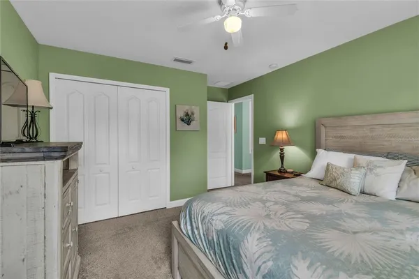 an aerial view of city and lake with trees all around