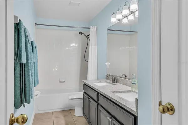 an aerial view of a house with a yard and lake view