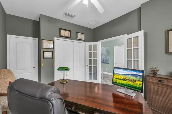 a kitchen with granite countertop a refrigerator and a stove top oven