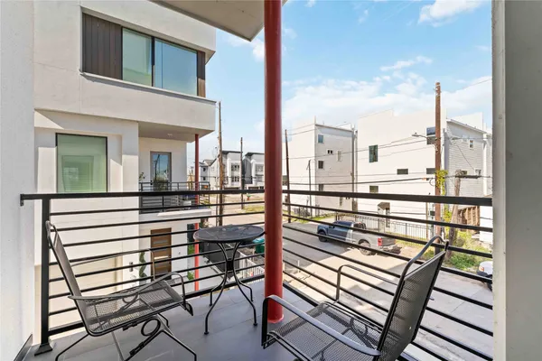 a view of a balcony with chairs