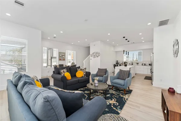 a living room with furniture and kitchen view