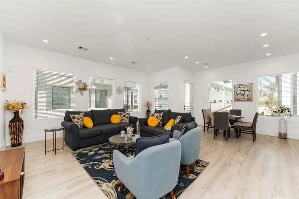 a living room with furniture and wooden floor
