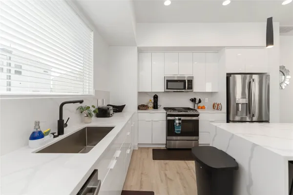 a kitchen with a sink a stove and refrigerator