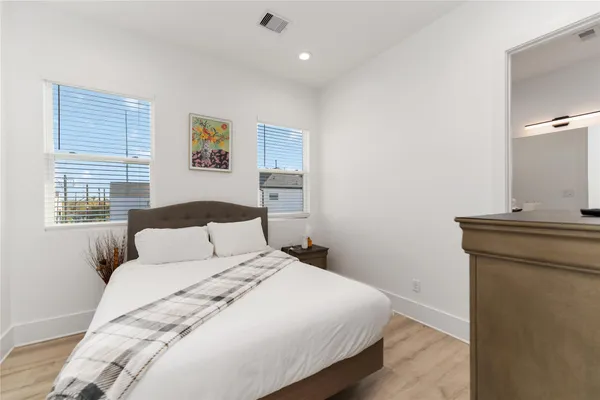 a bedroom with a large bed and a window