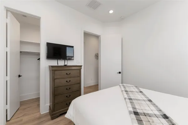 a bedroom with a bed and a flat screen tv