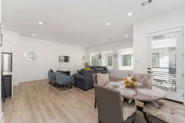 a living room with furniture two window and a table
