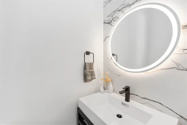 a bathroom with a sink and mirror