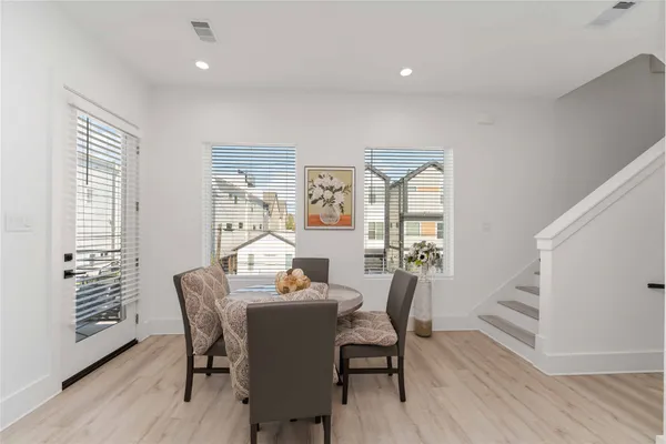 a view of a dining room with furniture window and wooden floor