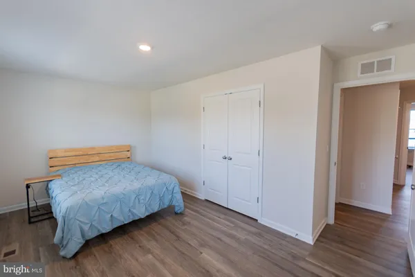 a view of an empty room and wooden floor