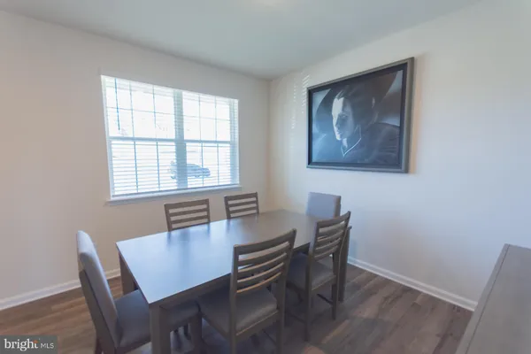 a view of a dining room with furniture and window