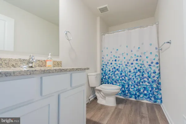 a view of a patio with couches chairs and wooden floor