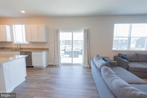 a kitchen with stainless steel appliances granite countertop a sink stove and microwave