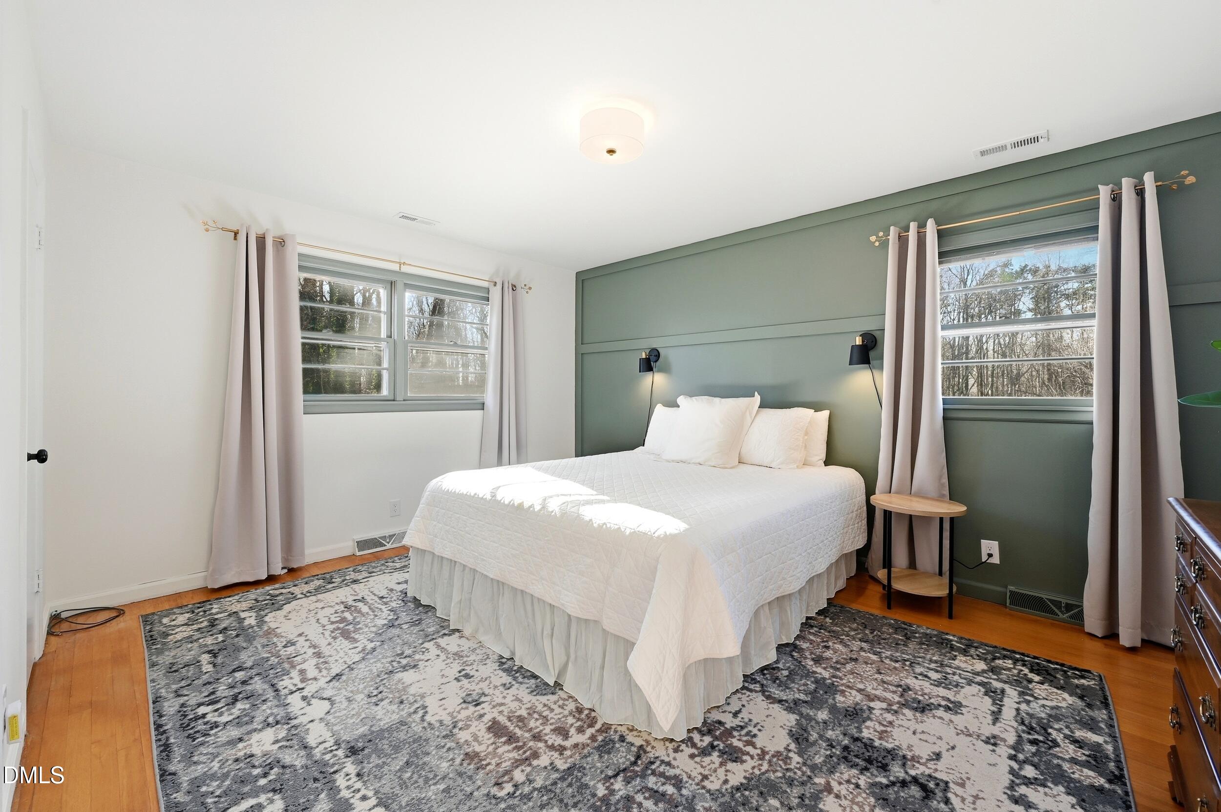 608 Hillhaven Terrace Roxboro, NC 27573 - Photo 16 of 31 a bedroom with a bed and wooden floor