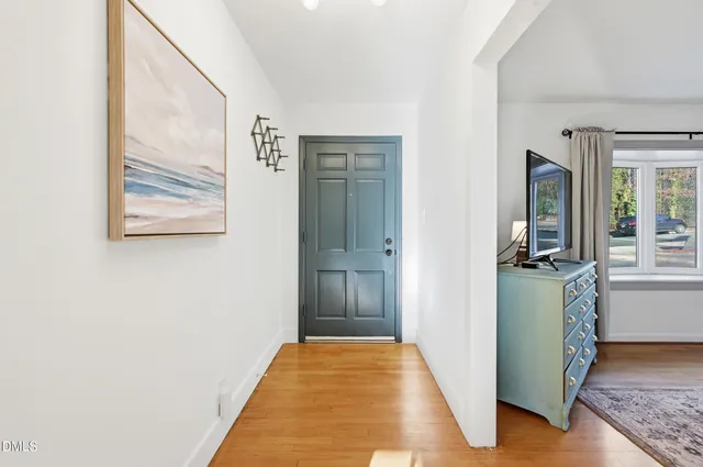 a view of a hallway with windows and entryway