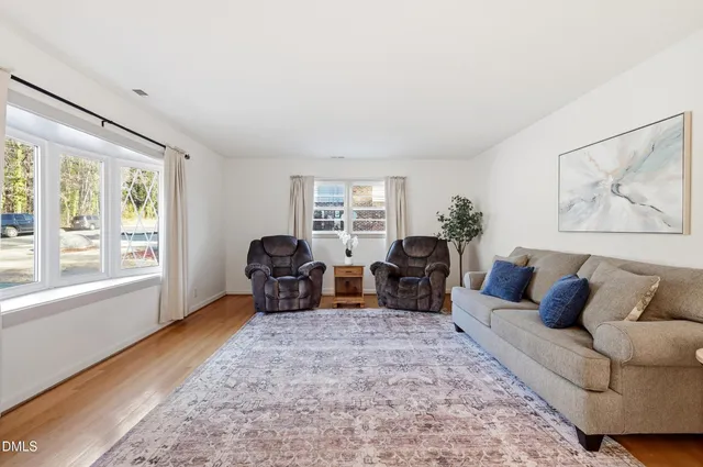 a living room with furniture large window and lamp