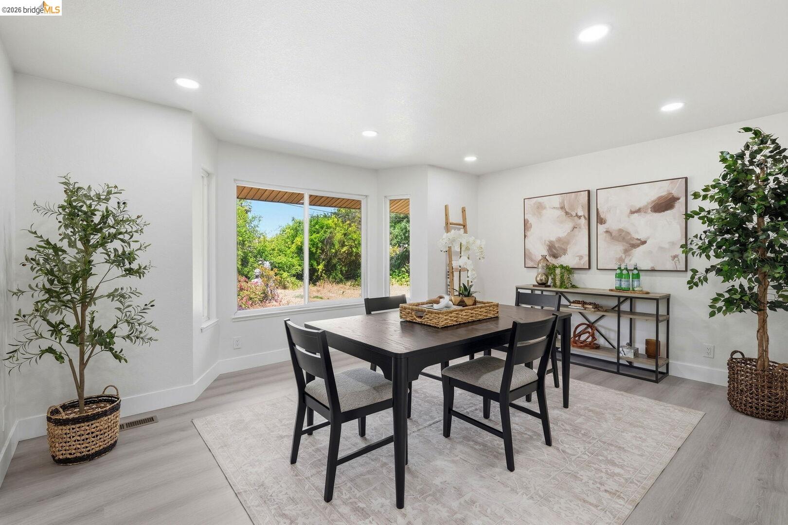 1590 Sunset Road Brentwood, CA 94513 - Photo 14 of 45 Dining area featuring bay windows, light wood-finish flooring, recessed lighting, and crisp white walls
