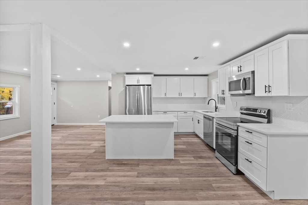 54 Mildred Road Brockton, MA 02302 - Photo 11 of 30 a view of kitchen with wooden floor and electronic appliances