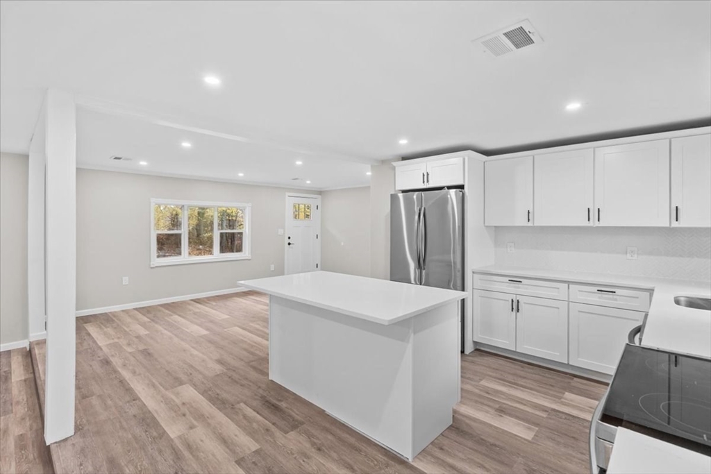 54 Mildred Road Brockton, MA 02302 - Photo 12 of 30 a kitchen with stainless steel appliances a refrigerator sink and cabinets