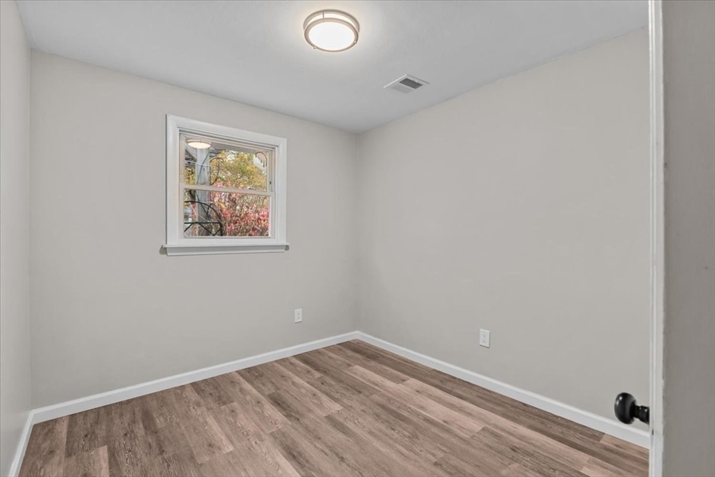 54 Mildred Road Brockton, MA 02302 - Photo 19 of 30 a view of empty room with wooden floor and fan