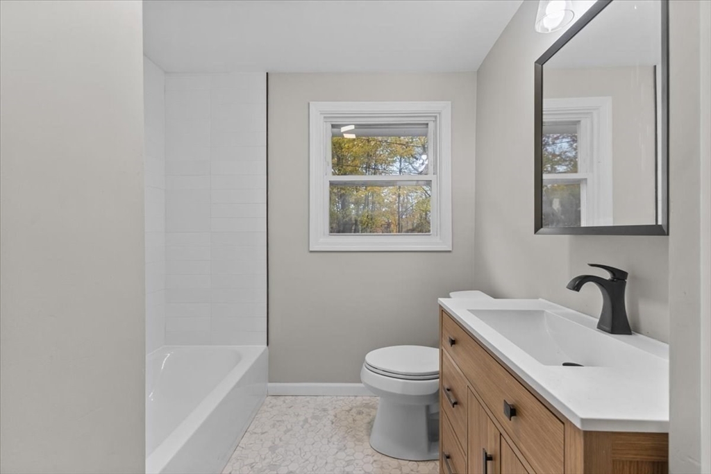 54 Mildred Road Brockton, MA 02302 - Photo 21 of 30 a white toilet sitting next to a bathroom sink