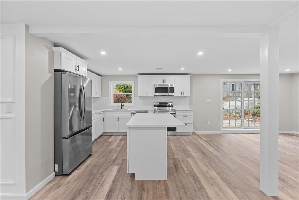 54 Mildred Road Brockton, MA 02302 - Photo 7 of 30 a kitchen with stainless steel appliances a refrigerator and a wooden floor