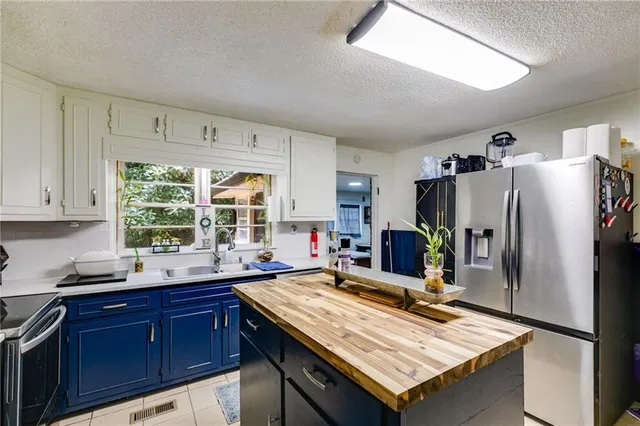 a kitchen with refrigerator and window