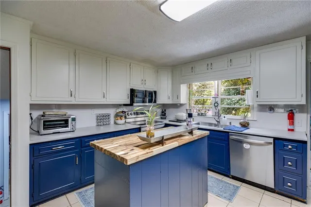 a kitchen with a sink stove top oven and cabinets