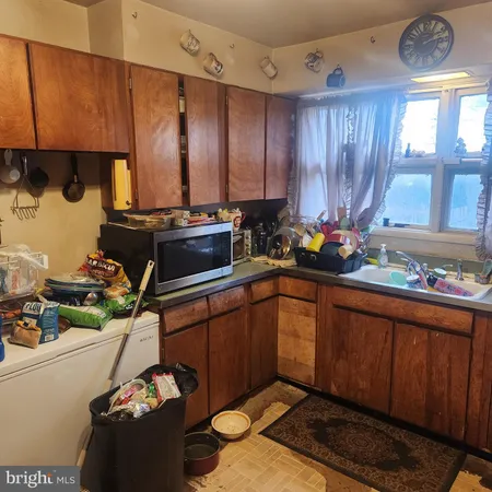 a kitchen with a refrigerator and a stove