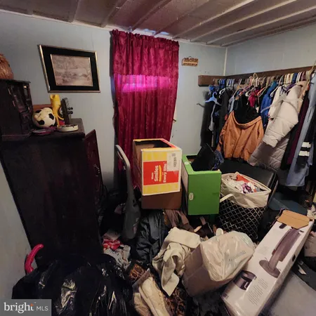 a view of a workspace with furniture and clothes