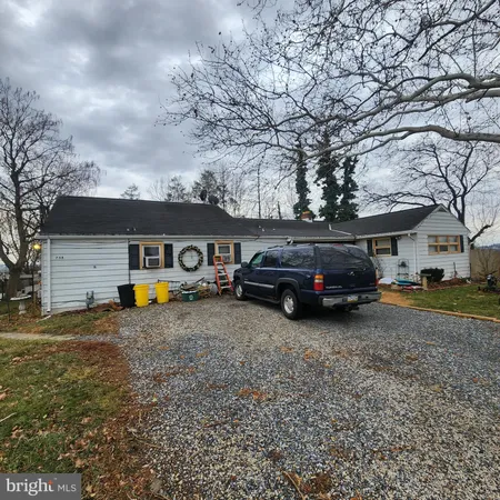 a view of a house with truck parked on the road