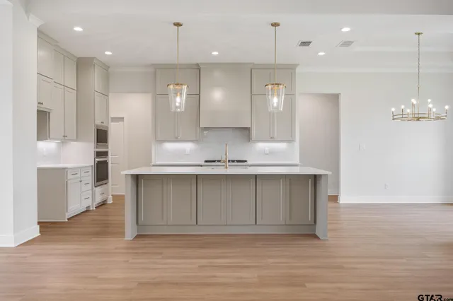 a view of kitchen with granite countertop cabinets and refrigerator