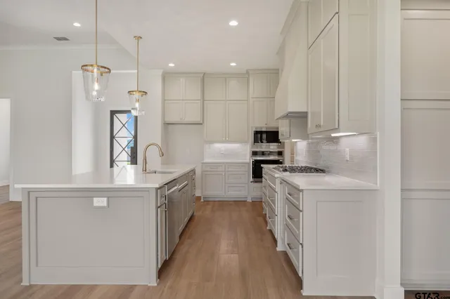 a kitchen with a sink stove and refrigerator