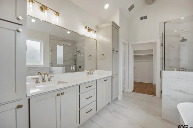 a spacious bathroom with a double vanity sink mirror and double
