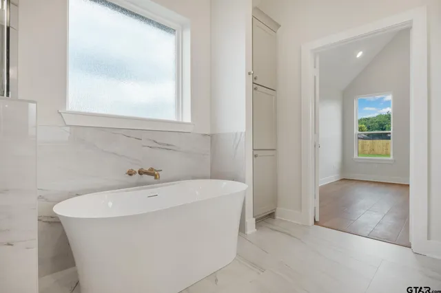 a bathroom with a bathtub and a sink
