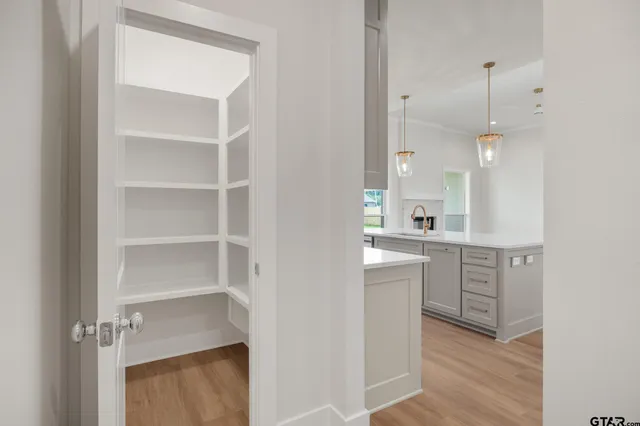 a room with white cabinets and white appliances