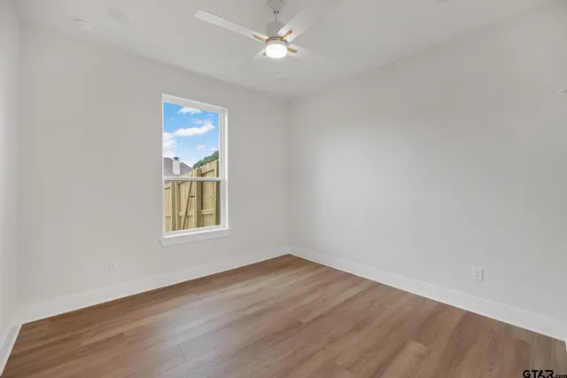 wooden floor in an empty room with a window