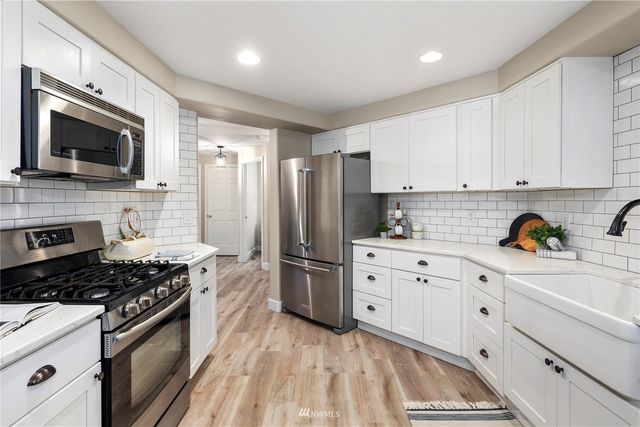 a kitchen with a sink and cabinets