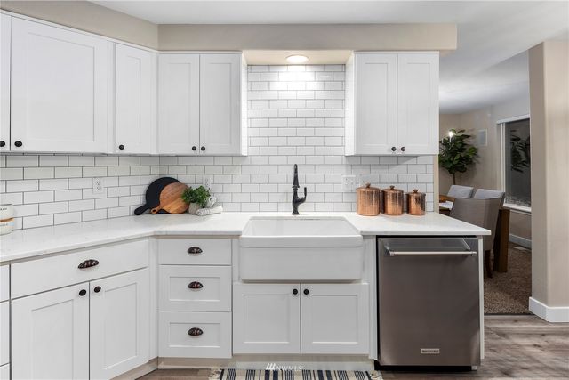 a kitchen with stainless steel appliances a stove a microwave and cabinets