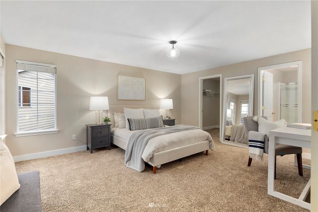 a bedroom with a bed and a desk