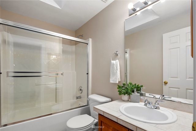 a bedroom with a bed and lamp