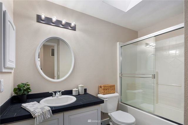 a view of a house with swimming pool and sitting area