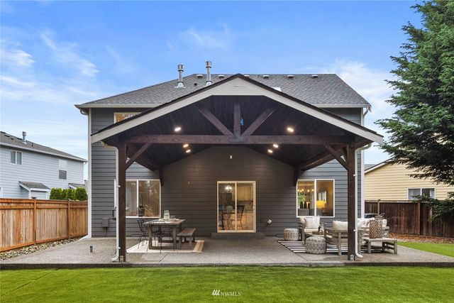 a backyard of a house with outdoor seating