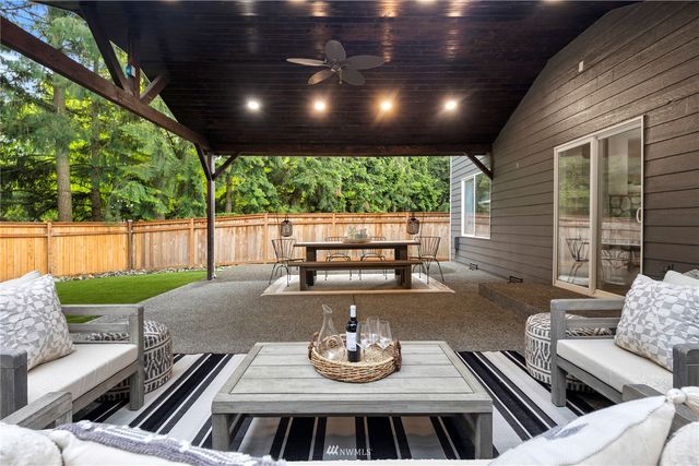 a view of a house with a yard patio and a fire pit