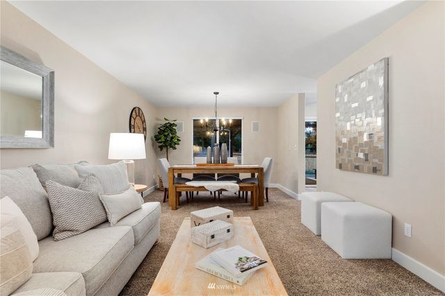 a view of a dining room with furniture and chandelier