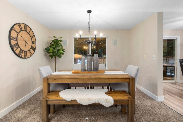 a view of a dining room with furniture wooden floor and chandelier