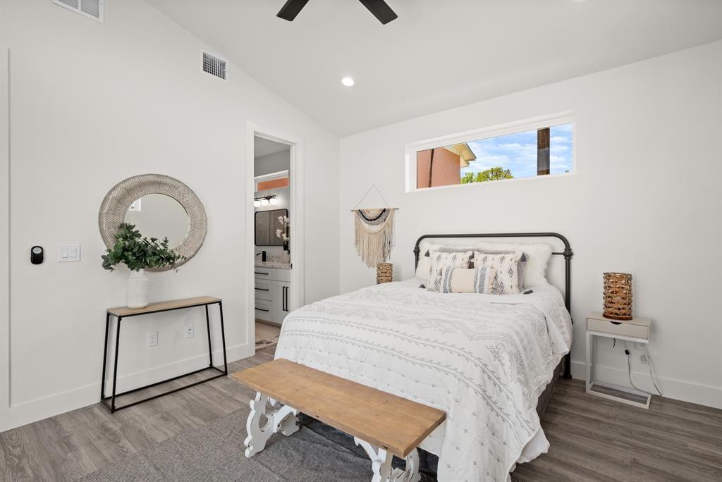 1606 Harvey Street, Unit 2 Austin, TX 78702 - Photo 12 of 22 Bright bedroom featuring wood-finish flooring, a contemporary ceiling fan, and a high horizontal window
