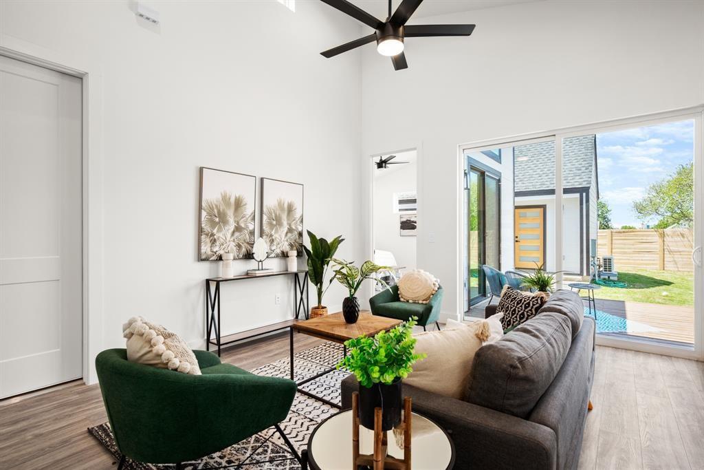 1606 Harvey Street, Unit 2 Austin, TX 78702 - Photo 9 of 22 Vaulted ceilings define this living space, complemented by wood-finish flooring and a contemporary ceiling fan