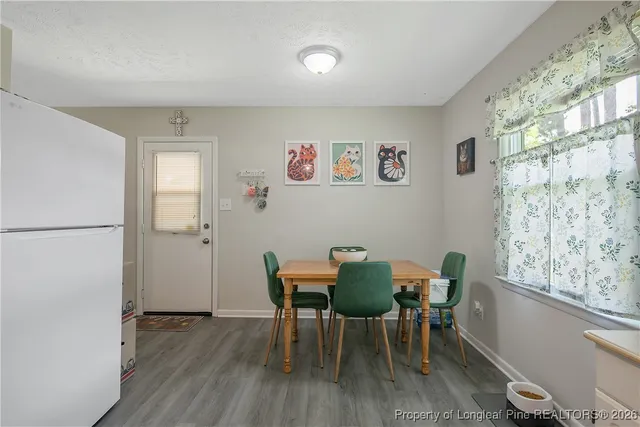 a view of a dining room with furniture and a window